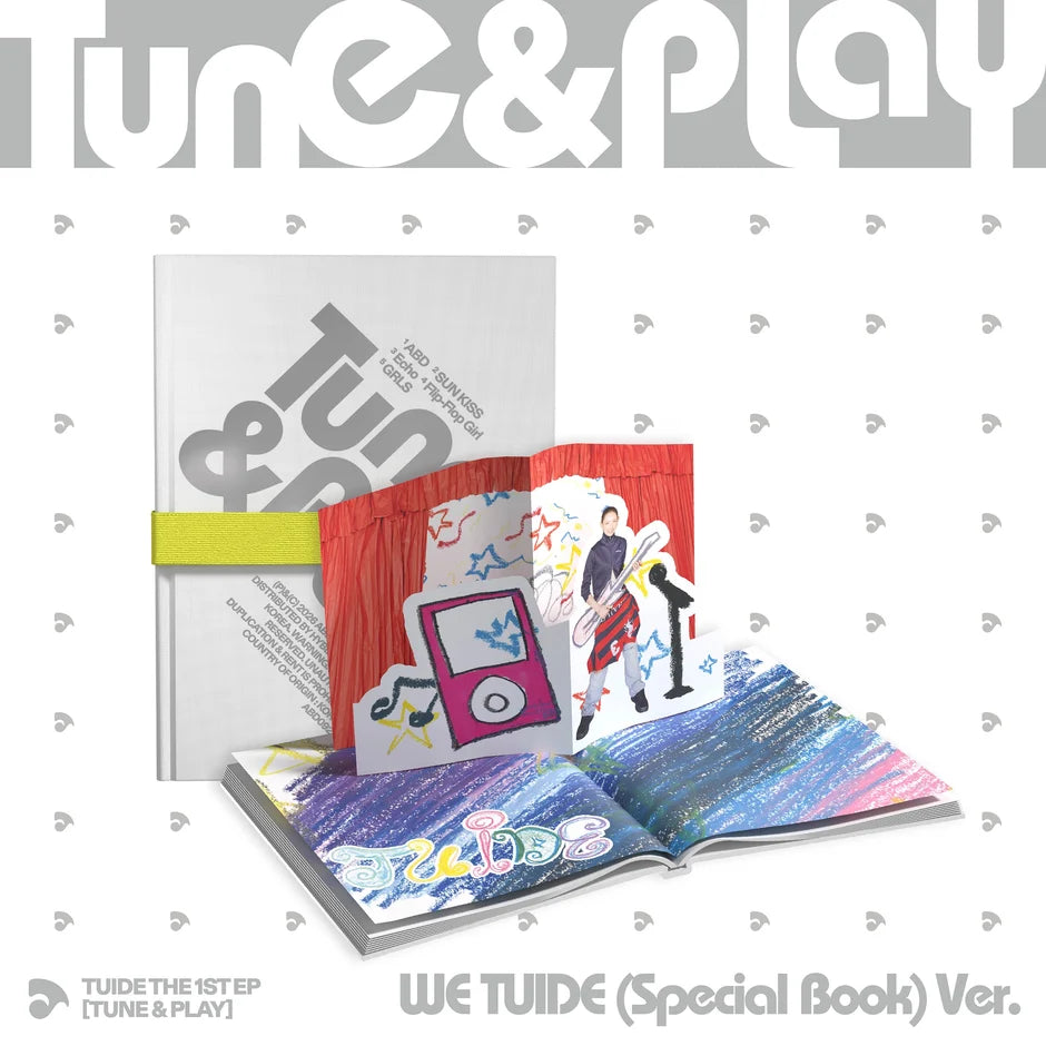 Tune & Play We Tuide (Special Book) Ver. album packaging shown on a white patterned background, featuring a closed book with a gray cover, an open red-and-white illustrated pop-up book, and an open blue-and-purple illustrated book.