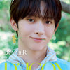 A close-up portrait of a young man outdoors with green foliage blurred in the background. He is wearing a light blue collared shirt and holding a small yellow flower between his lips. Large overlaid text reads 'AND THE SUMMER AND2BLE YOO SEUNGEON' with 'D'ICON' at the bottom