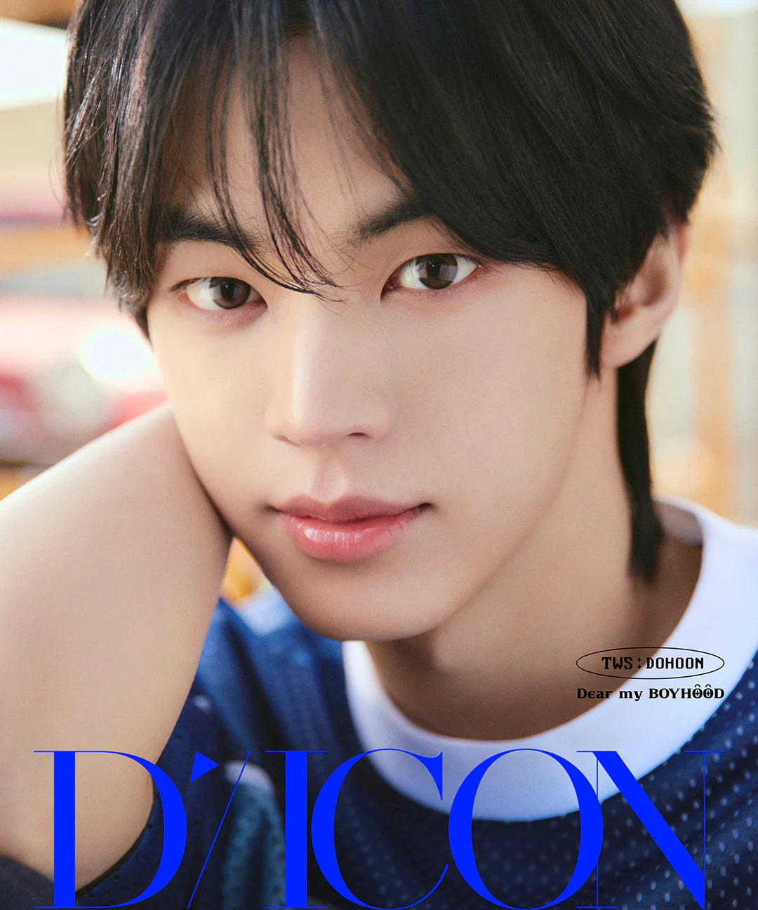 TWS's Dohoon wearing a blue shirt with 'D'Icon' branding as the foreground
