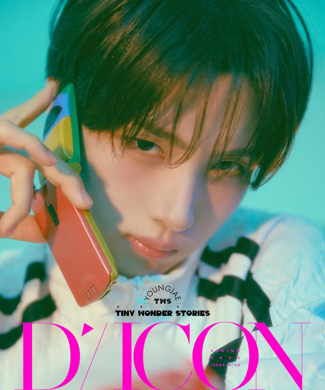 TWS's Youngjae holding colorful phone with 'D'Icon' branding in the background
