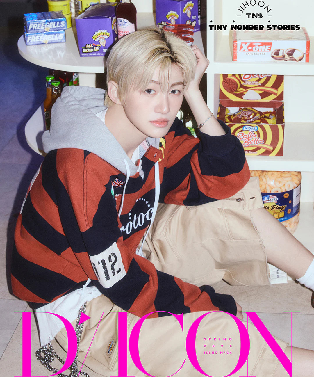 TWS's Jihoon wearing a striped hoodie sitting in front of shelves with snacks, with 'D'ICON' branding.