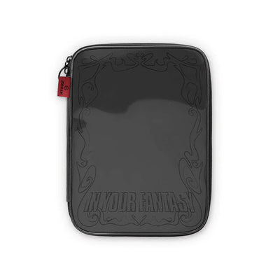 A black zippered sleeve or pouch with a glossy finish for ATEEZ's 2025 world tour, featuring embossed decorative scrollwork and the text 'IN YOUR FANTASY' near the bottom. A small red fabric tag is visible on the left zipper pull.