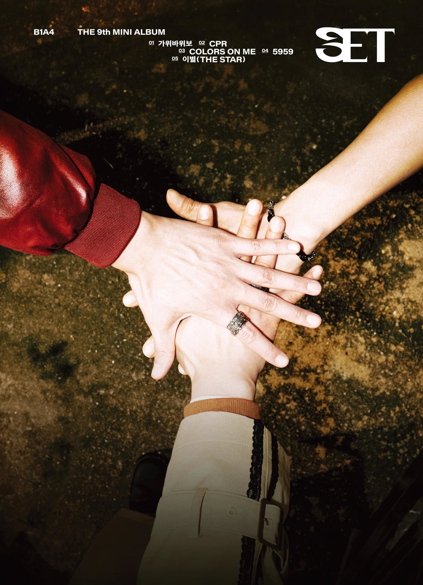 Four hands stacked together with a dark background, featuring the 'SET' logo of B1A4's album.