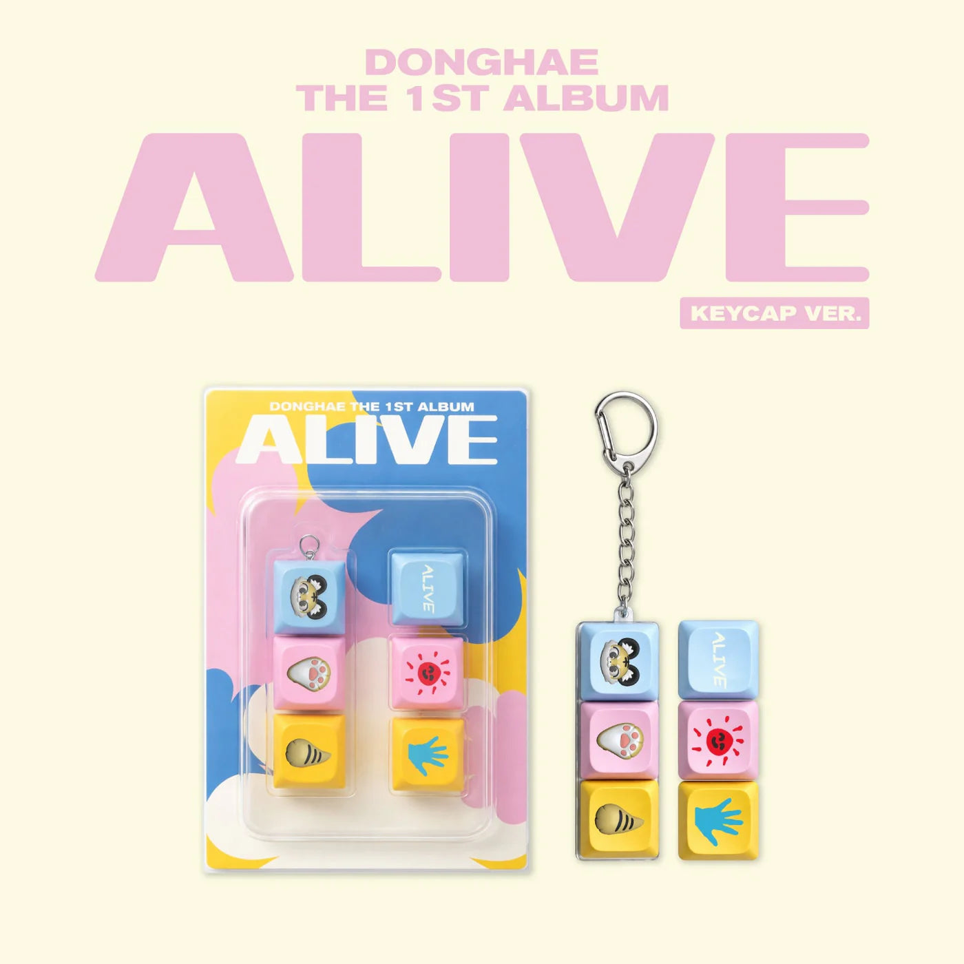 Album packaging and keychain with colorful keycaps on a light pink background