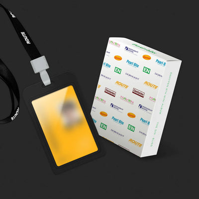 A black lanyard with a white plastic clip and a black ID badge holder containing a yellow card, shown next to its white branded retail box on a dark background for ENHYPEN's 'The Sin: Bliss' album