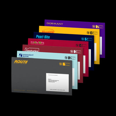 A fan arrangement of ENHYPEN's The Sin: Bliss Engene ver custom envelopes in various colors, including purple, yellow, blue, red, maroon, and gray, displayed against a solid black background.