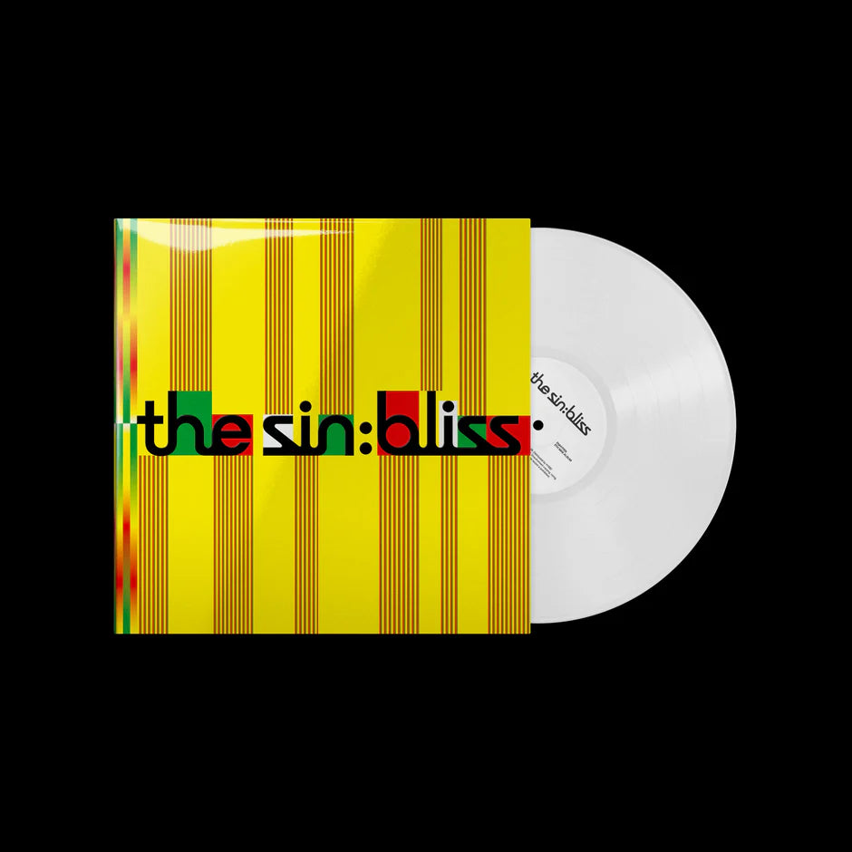 ENHYPEN's vinyl record album with a yellow striped cover and a translucent white record partially visible behind it, shown on a black background. The cover text reads 'the sin: bliss'.