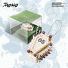 Product packaging of ITZY's album Motto with a cake-shaped keychain with '05' on a light blue background