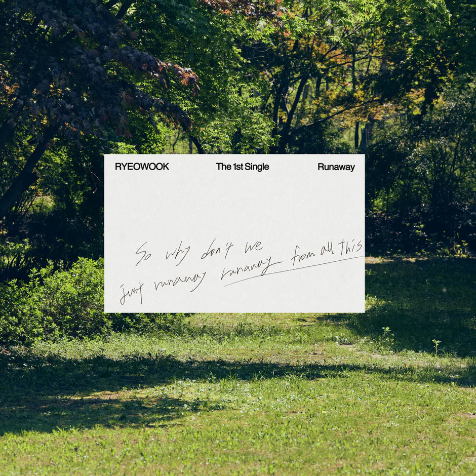 Promotional photo of RyeoWook's 1st single album with a white sheet with text written on it and a forest setting as the backdrop