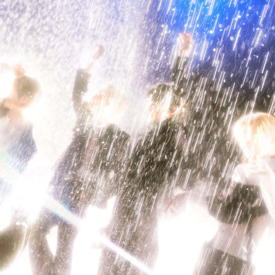 Promotional image for SHINee's 6th mini album shown with people celebrating with confetti in a festive setting 