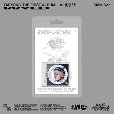 Album packaging for Taeyong's first album 'WYLD' with a rose design on a gray background