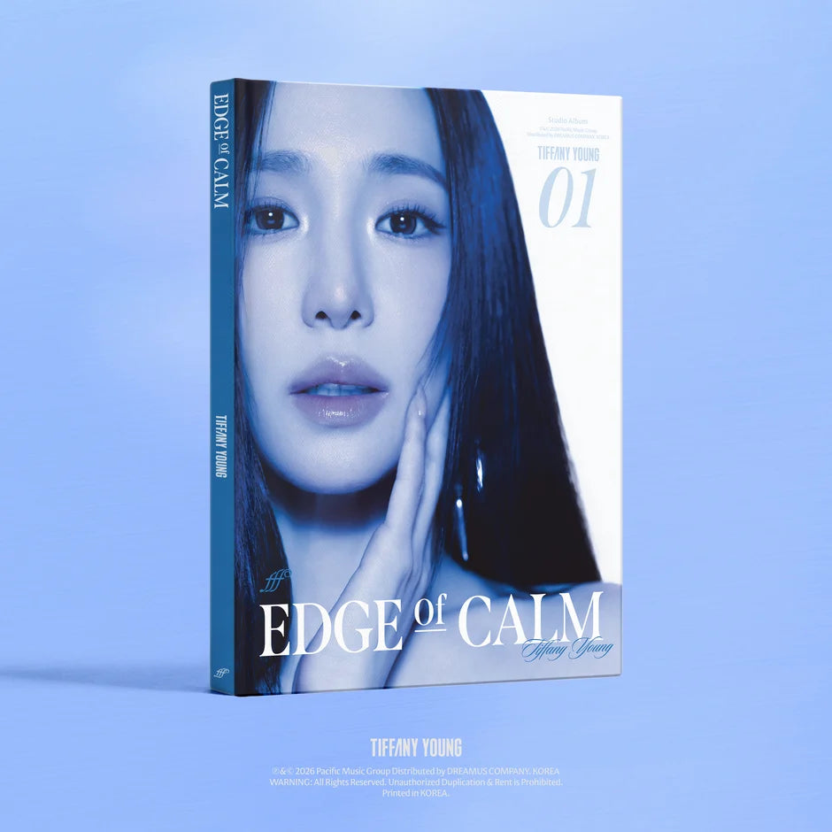 A hardcover book or album cover titled 'EDGE of CALM' by Tiffany Young, shown standing upright on a light blue background. The cover features a close-up portrait of Tiffany Young in cool blue and white tones, with the spine visible on the left.
