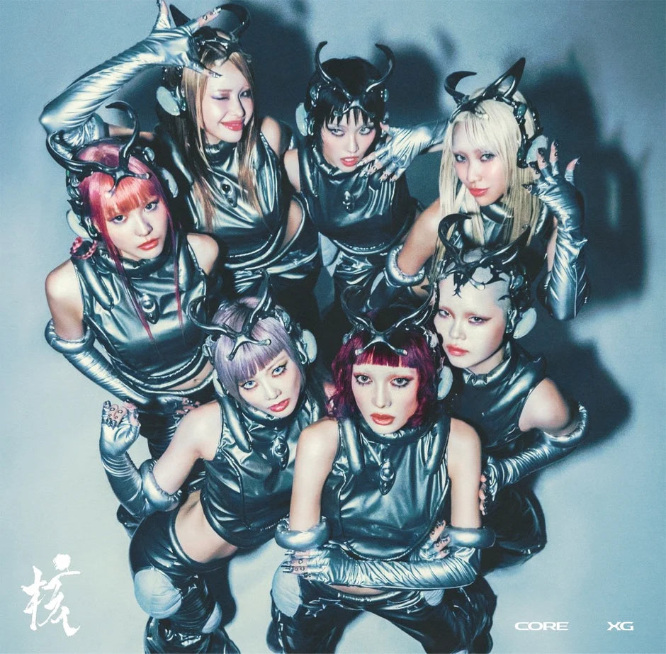 XG members in metallic costumes with horns against a gray background