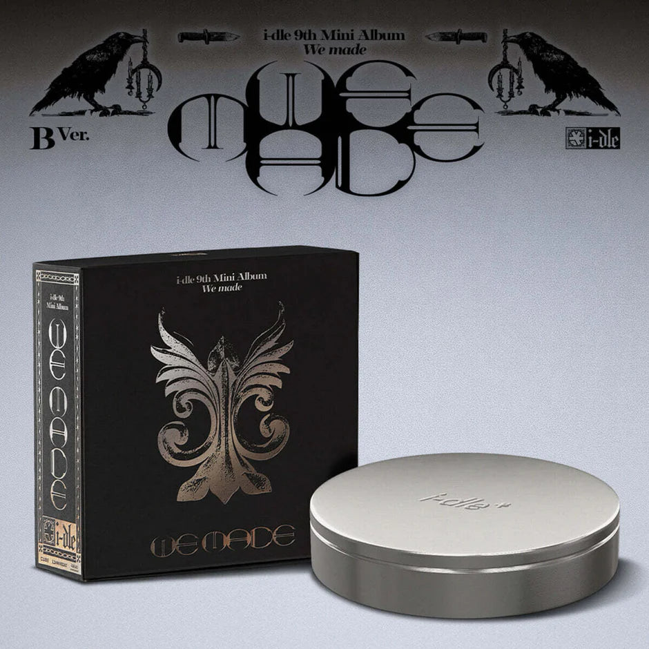 i-dle's black album packaging with silver lid on a gray background, featuring the 'idle' logo.