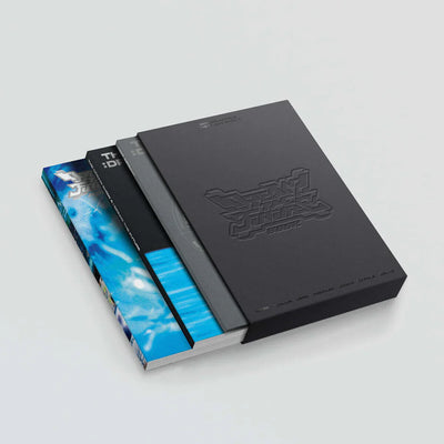 Three books of NCT Dream, one with a blue abstract design, the other black with embossed text, and a third one with a light gray background.